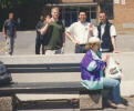 Ryan O, Roy and Chris wave to the camera.  The old lady doesn't look impressed